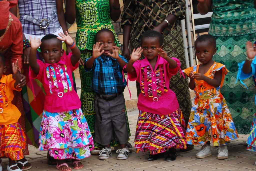 Little girls and boys wave their hands in celebration at the Christmas party