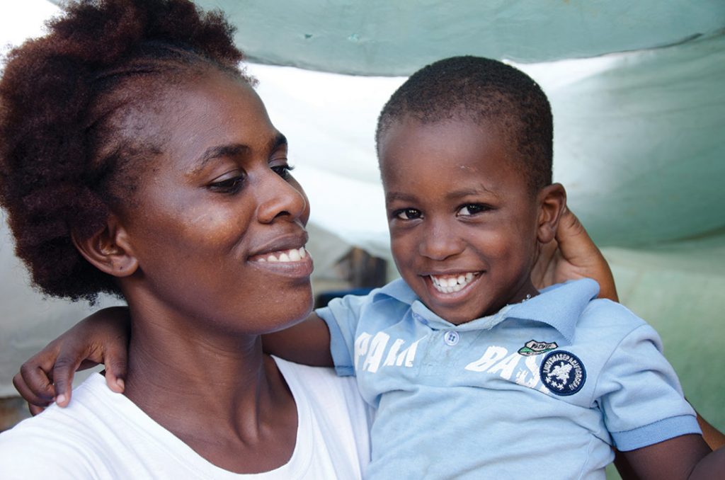 Maria Elena sits with her son.