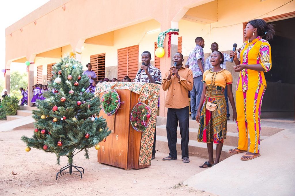 Child centre volunteers perform a Christmas song.