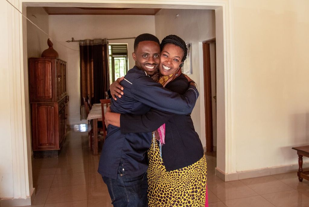 Christian and Pascasie share a joyful embrace.
