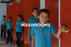 Image of some boys outside a washroom. Image says washroom.