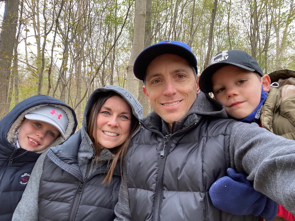 John and his family on a hike in the forest.