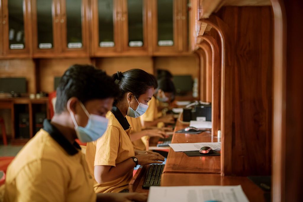Youth in Indonesia working in a computer lab.