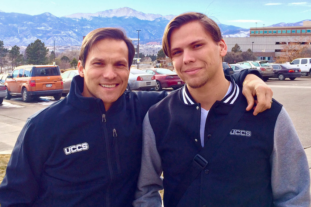 Jimmy stands with his arm around his son.